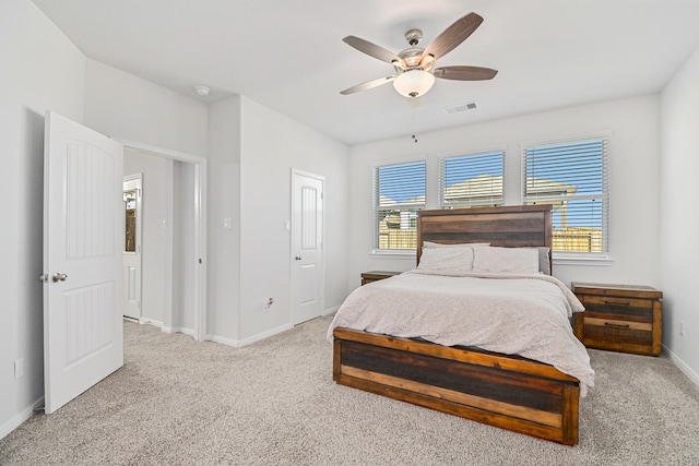 carpeted bedroom with multiple windows and ceiling fan