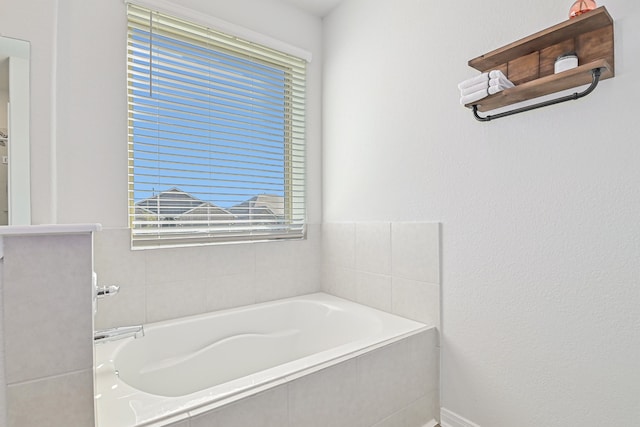 bathroom featuring a relaxing tiled tub