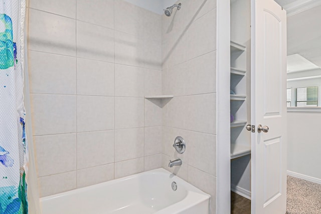 bathroom featuring crown molding and shower / bath combo with shower curtain