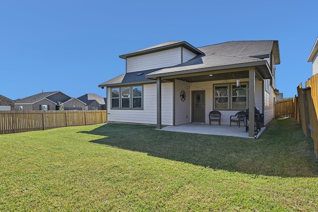 back of property with a lawn and a patio