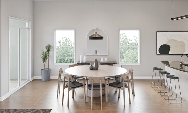 dining space with a towering ceiling and a wealth of natural light