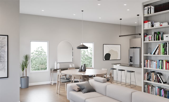 living room with wood-type flooring and a high ceiling