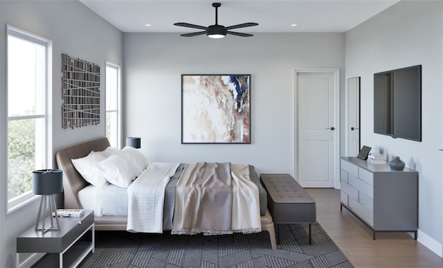 bedroom with dark hardwood / wood-style flooring and ceiling fan