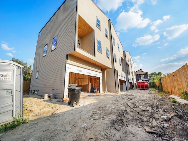 rear view of house featuring a garage