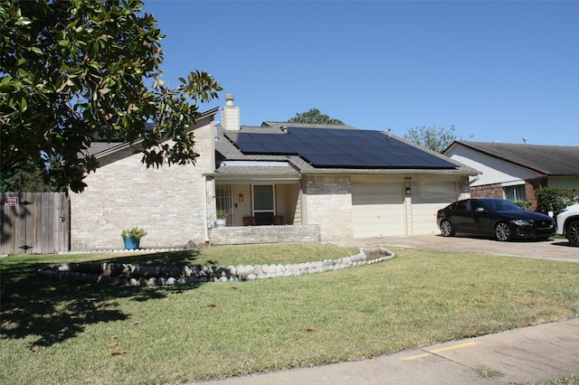 view of front of house featuring solar panels, a garage, and a front lawn