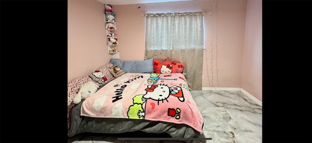 bedroom with marble finish floor and baseboards