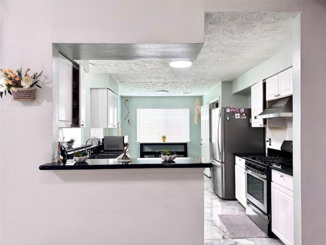 kitchen with dark countertops, marble finish floor, stainless steel appliances, under cabinet range hood, and a sink