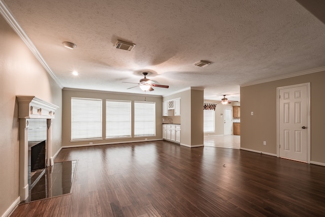 unfurnished living room with ornamental molding, a textured ceiling, ceiling fan, and dark hardwood / wood-style flooring