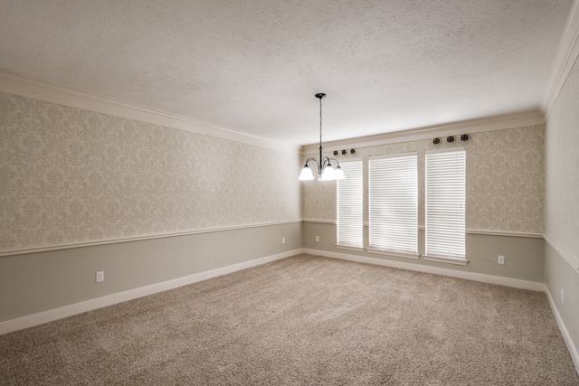 carpeted empty room with a textured ceiling, crown molding, and a notable chandelier