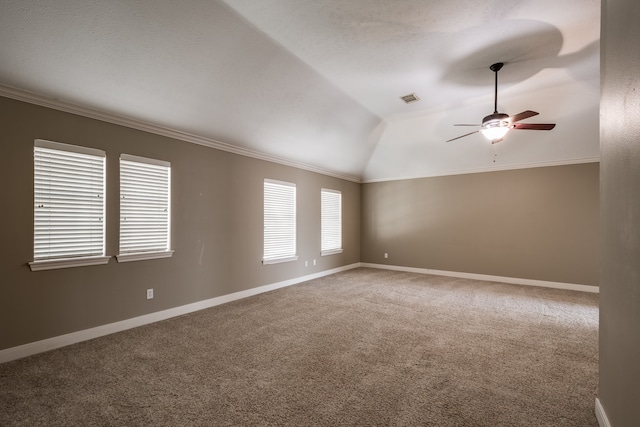 spare room featuring ceiling fan, lofted ceiling, crown molding, and carpet flooring