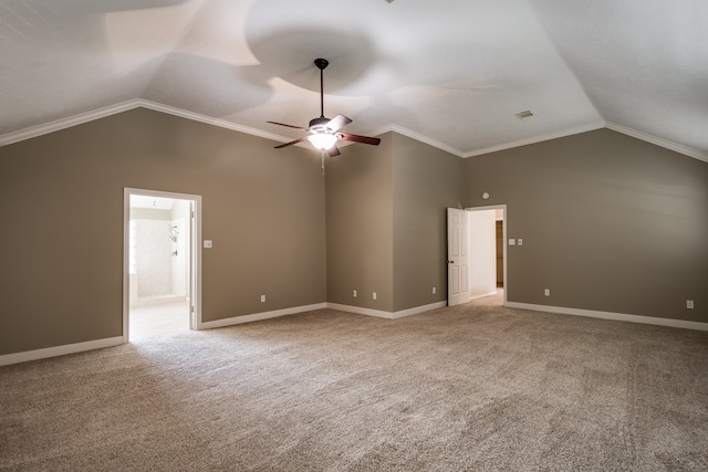 carpeted spare room with vaulted ceiling, ceiling fan, and crown molding