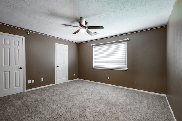 unfurnished bedroom with ceiling fan, carpet floors, and a textured ceiling