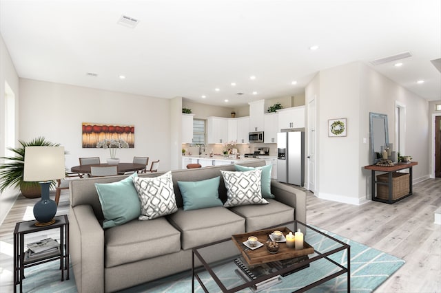 living room with sink and light hardwood / wood-style flooring