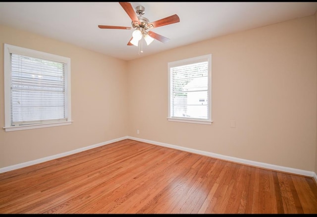 spare room with light hardwood / wood-style flooring and ceiling fan