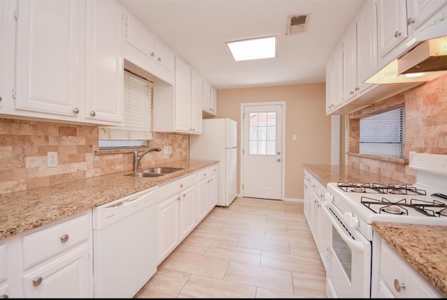 kitchen with backsplash, sink, white appliances, and white cabinetry