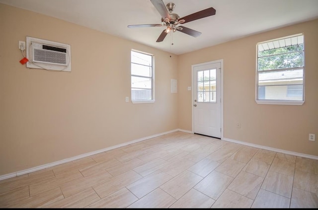 empty room with a wall unit AC and ceiling fan