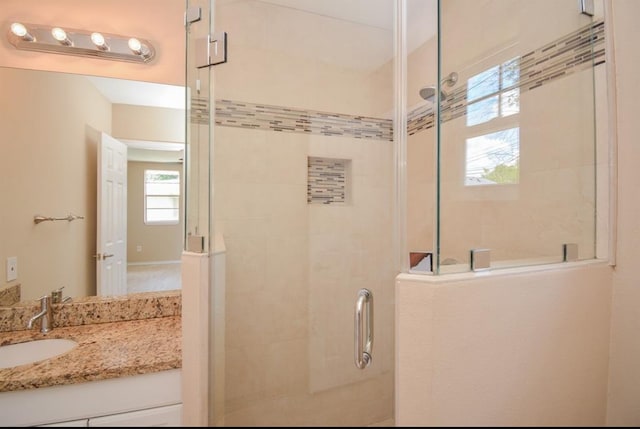 bathroom with vanity and a shower with shower door