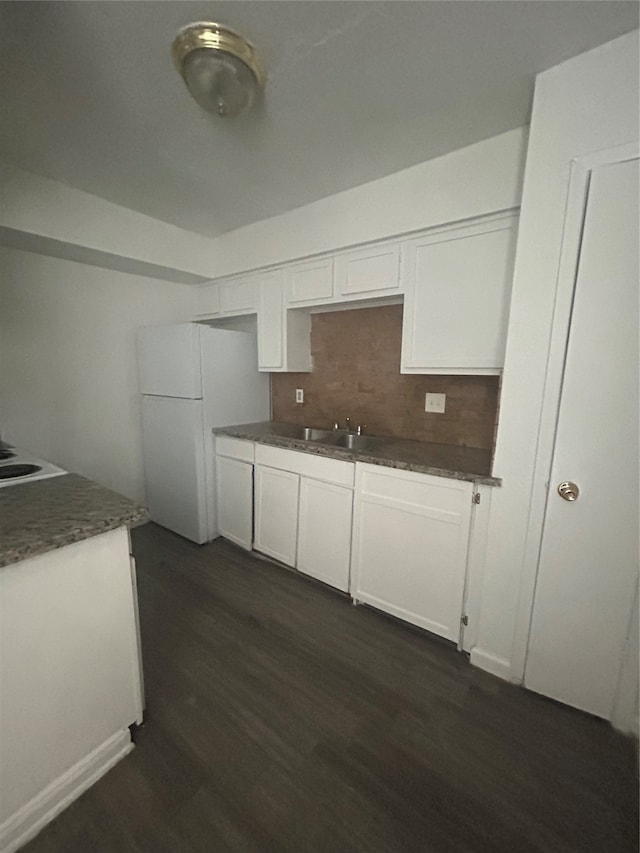 kitchen featuring white cabinets and tasteful backsplash