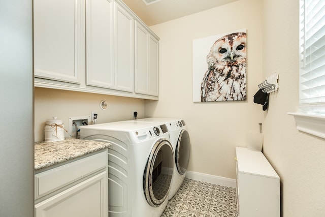 laundry room with separate washer and dryer, light tile patterned floors, and cabinets