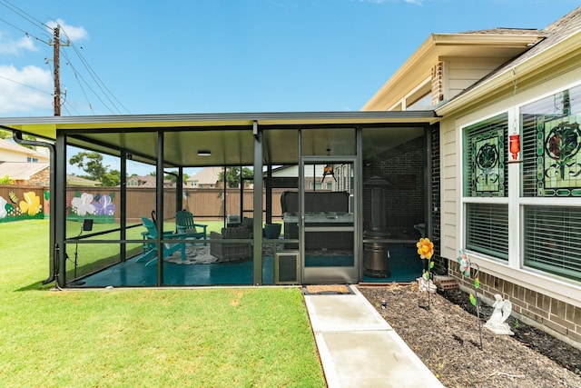 property entrance featuring a lawn and a patio area