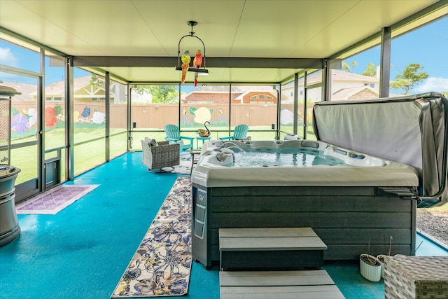 unfurnished sunroom with a hot tub