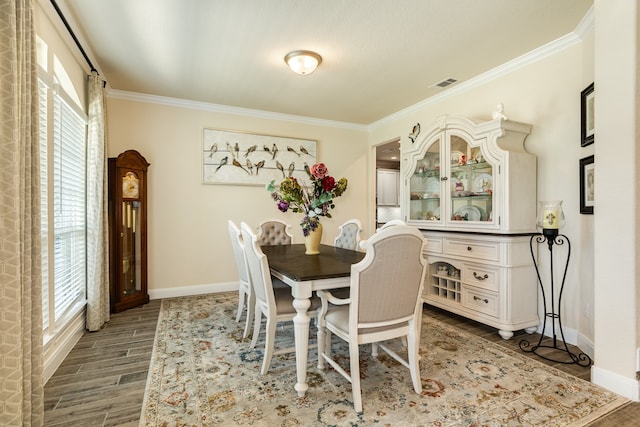 dining area with ornamental molding, hardwood / wood-style flooring, and a wealth of natural light