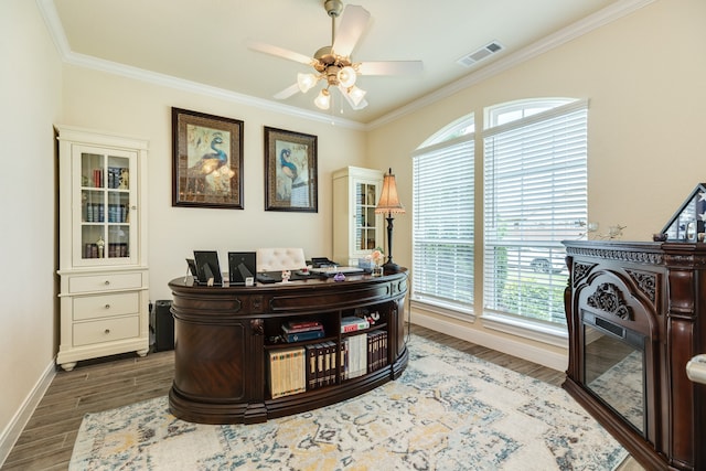 home office featuring ceiling fan, ornamental molding, dark wood-type flooring, and a wealth of natural light