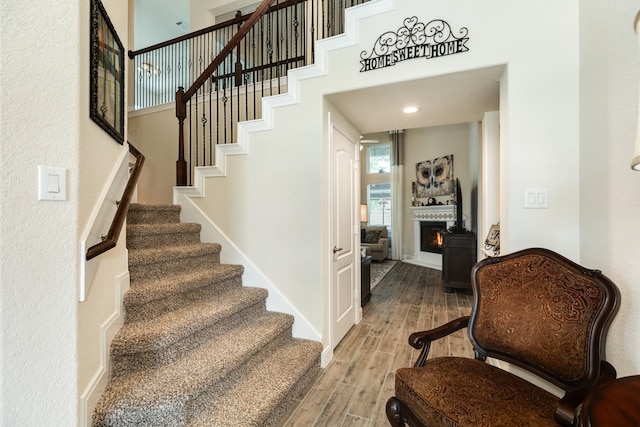 staircase with hardwood / wood-style floors