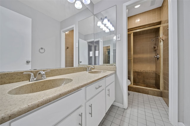 bathroom featuring vanity, toilet, tile patterned flooring, and a shower with door