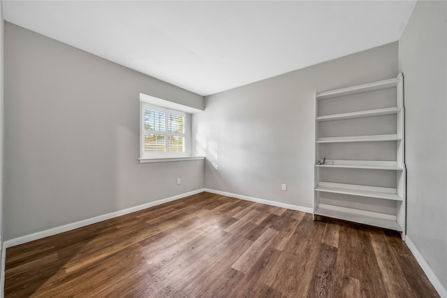 unfurnished bedroom featuring a closet and dark hardwood / wood-style floors