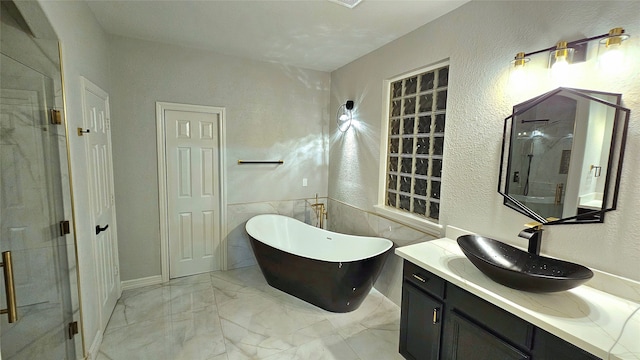 bathroom featuring vanity and separate shower and tub