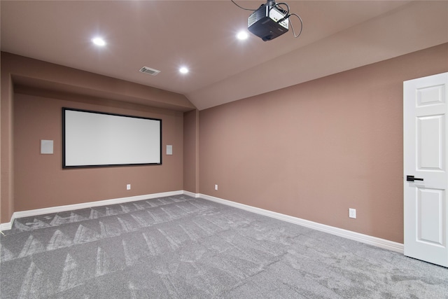 home theater featuring lofted ceiling and carpet