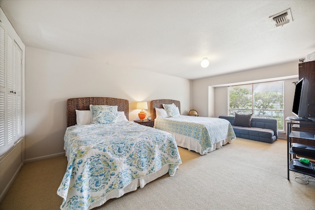 bedroom with light colored carpet