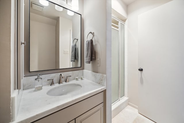 bathroom with vanity and an enclosed shower