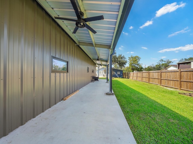 view of yard with fence, ceiling fan, and a patio