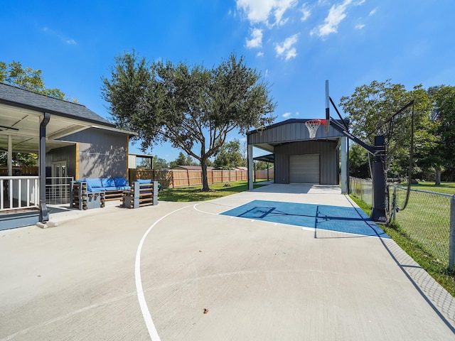 view of swimming pool with an outbuilding, a yard, basketball hoop, and fence