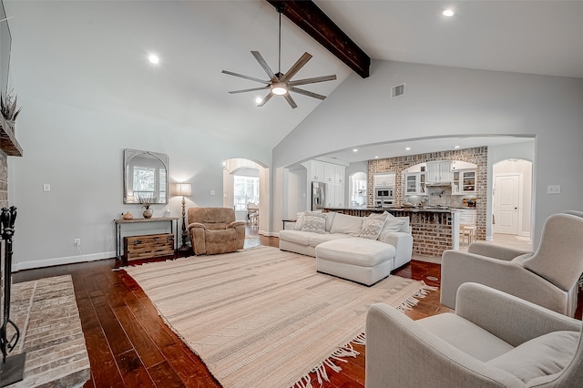 living room featuring beam ceiling, hardwood / wood-style flooring, high vaulted ceiling, and ceiling fan