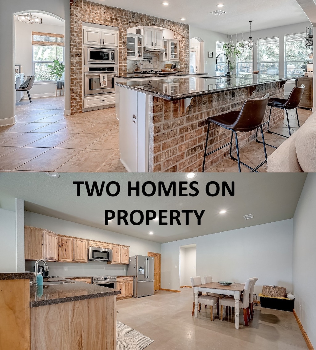 kitchen featuring a wealth of natural light, a spacious island, sink, and appliances with stainless steel finishes