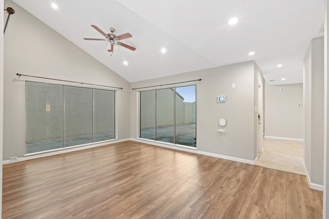 spare room with ceiling fan, light hardwood / wood-style floors, and high vaulted ceiling