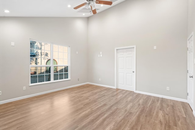 unfurnished room featuring high vaulted ceiling, light hardwood / wood-style floors, and ceiling fan