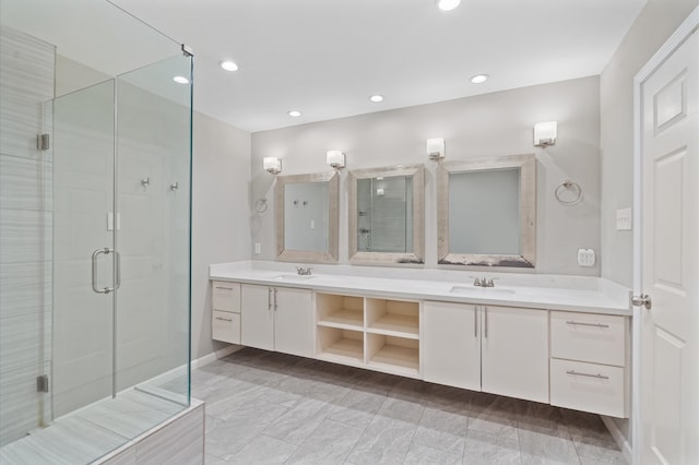 bathroom featuring vanity and a shower with shower door