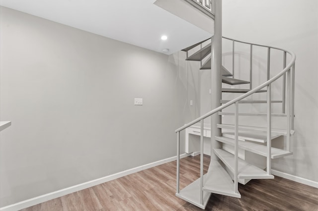 staircase with wood-type flooring