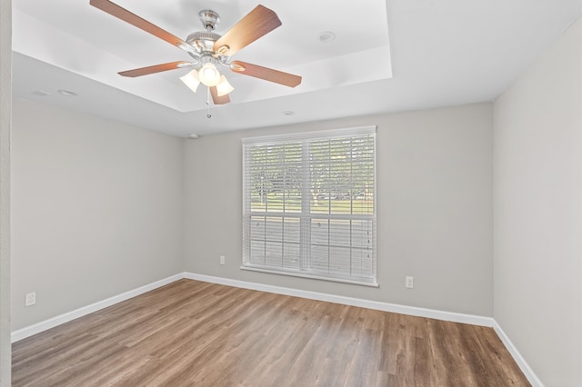 empty room featuring wood-type flooring and ceiling fan