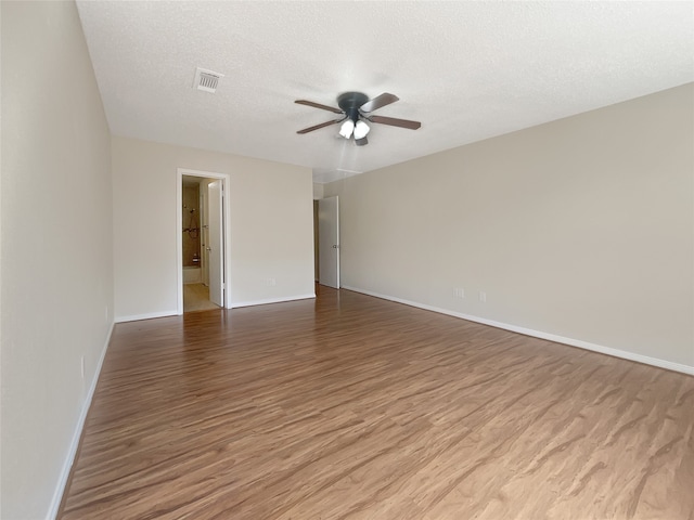 spare room featuring hardwood / wood-style floors, a textured ceiling, and ceiling fan