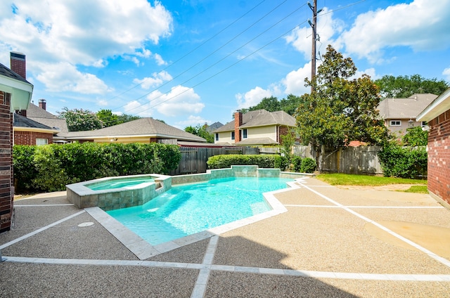 view of swimming pool with an in ground hot tub