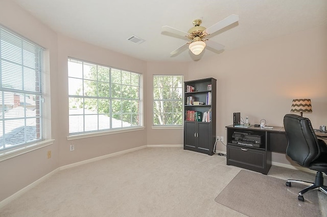 carpeted home office with ceiling fan