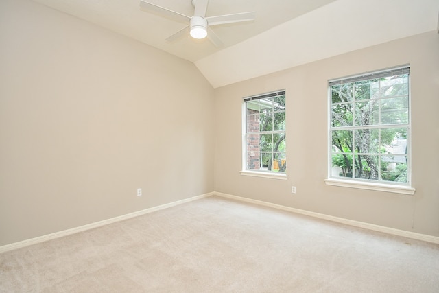 unfurnished room with vaulted ceiling, light carpet, and ceiling fan