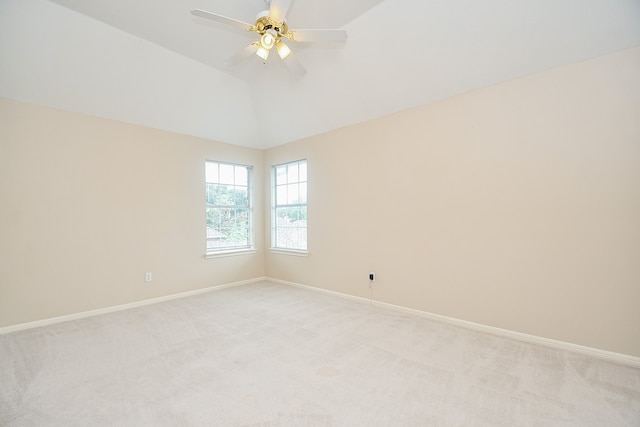 carpeted empty room featuring lofted ceiling and ceiling fan