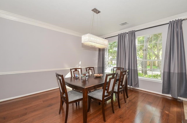 dining room with crown molding and dark hardwood / wood-style flooring