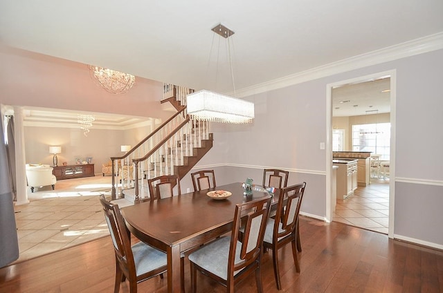 dining room featuring ornamental molding, a chandelier, and hardwood / wood-style flooring